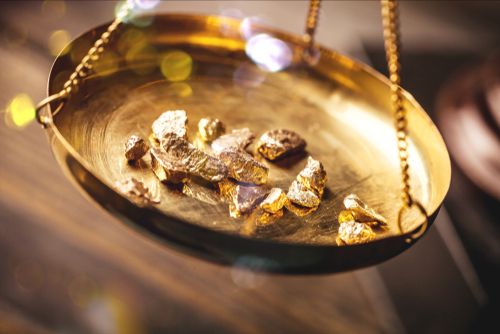 gold ingots being weighed